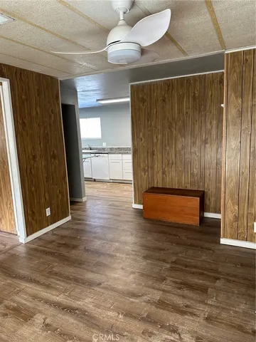 a view of a room with wooden floor and window