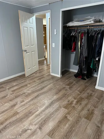 a view of walk in closet with clothes