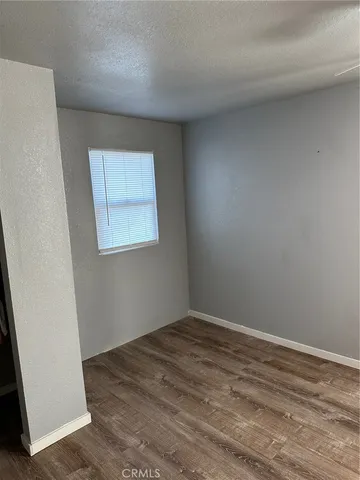 a bathroom with a granite countertop toilet and a sink