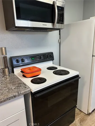 a kitchen with a stove and a microwave