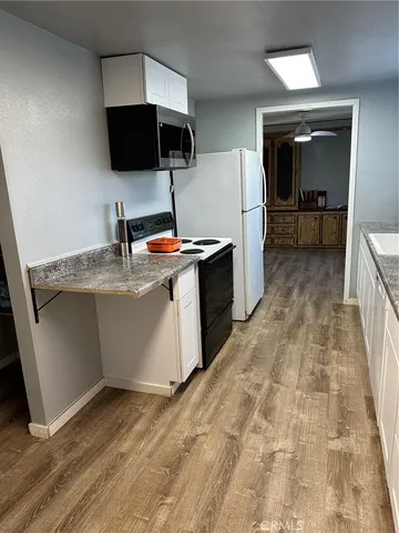 a kitchen with a sink appliances and cabinets