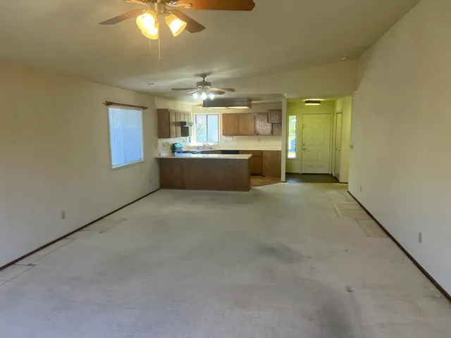 a kitchen with stainless steel appliances granite countertop a sink a stove and a refrigerator