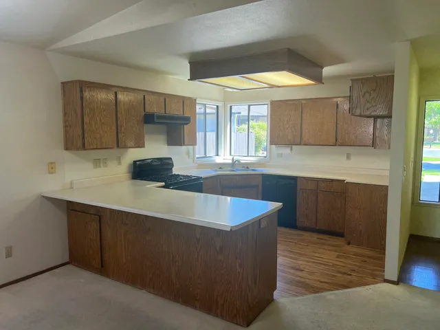 a kitchen with a sink and large window