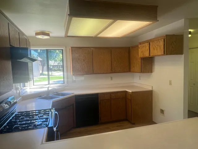 an empty room with a ceiling fan and carpet