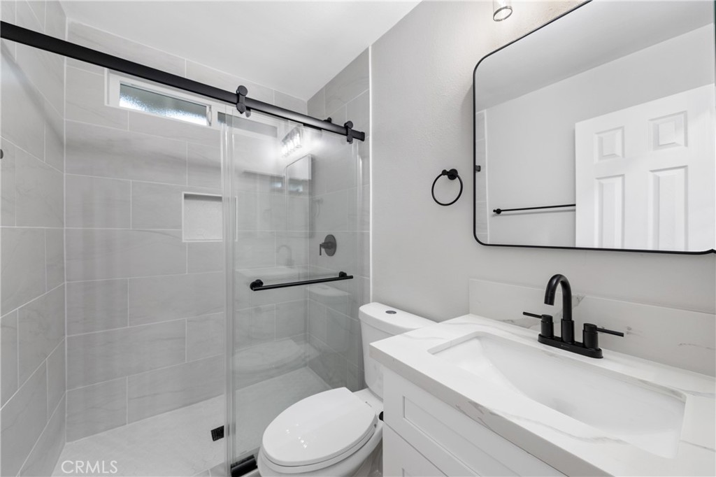 1413 Panorama Ridge Road Oceanside, CA 92056 - Photo 17 of 27 a bathroom with a sink toilet and shower