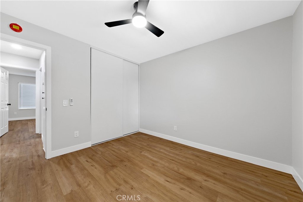 1413 Panorama Ridge Road Oceanside, CA 92056 - Photo 18 of 27 an empty room with wooden floor and windows