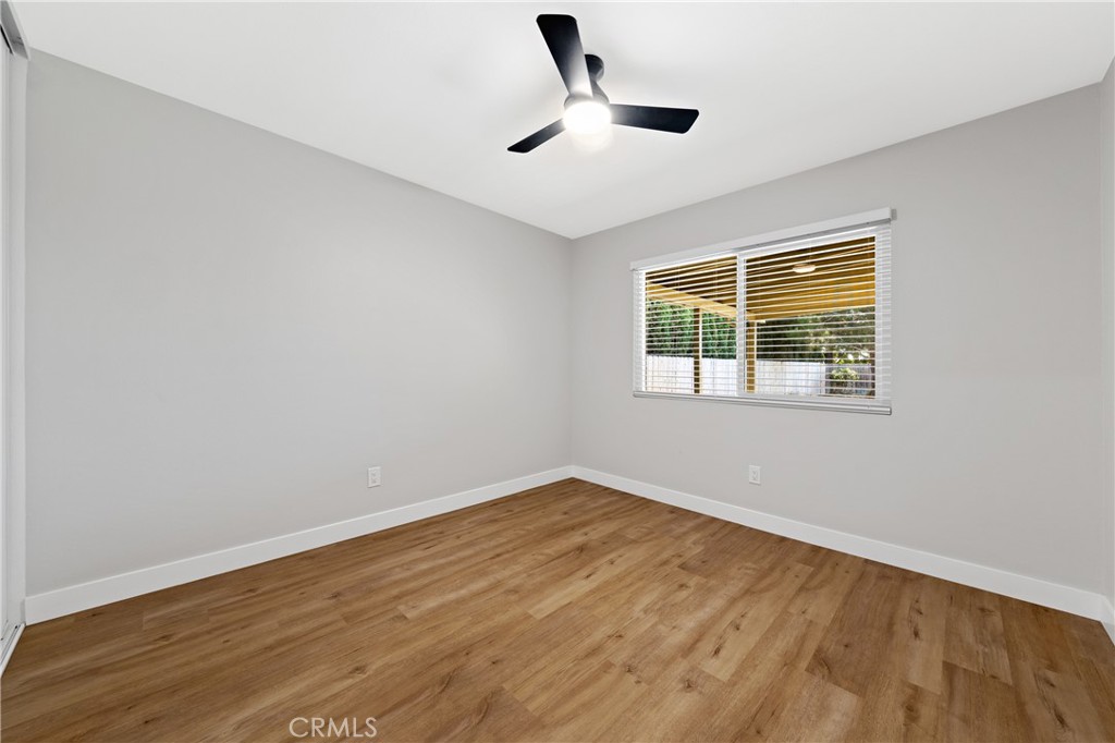 1413 Panorama Ridge Road Oceanside, CA 92056 - Photo 21 of 27 a view of an empty room with wooden floor and a window
