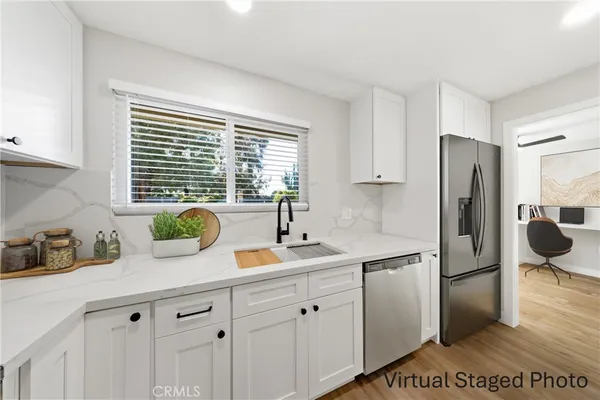 a kitchen with a refrigerator and a sink