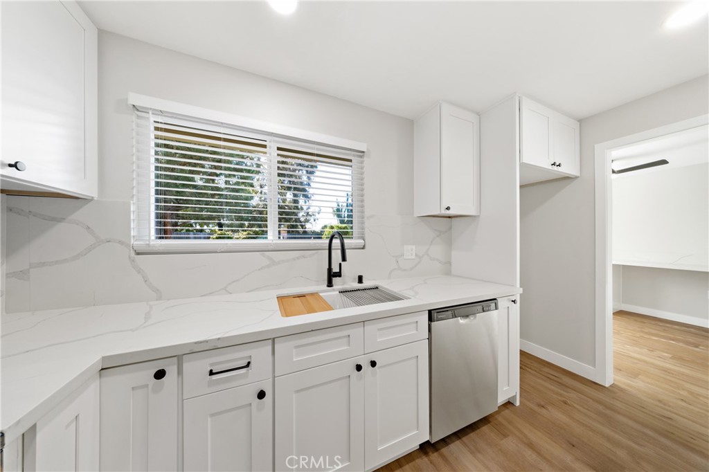 1413 Panorama Ridge Road Oceanside, CA 92056 - Photo 4 of 27 a kitchen with stainless steel appliances sink a window and wooden floor