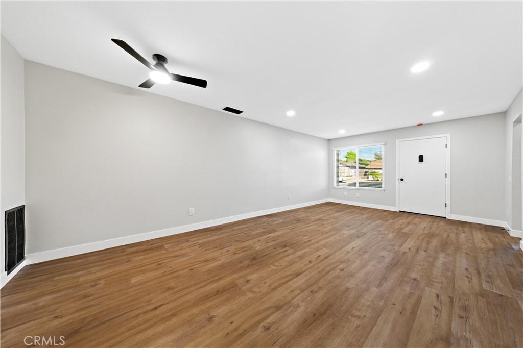 1413 Panorama Ridge Road Oceanside, CA 92056 - Photo 6 of 27 an empty room with wooden floor cabinet and windows