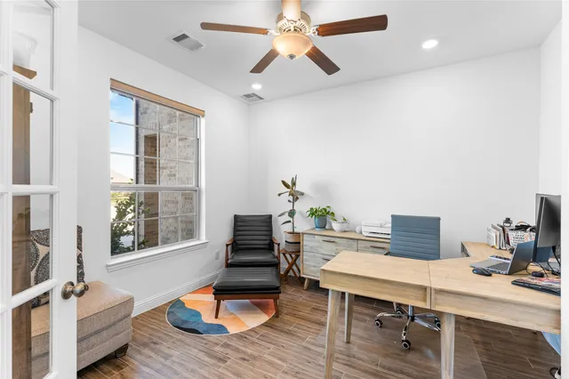 a living room with furniture flat screen tv and a large window