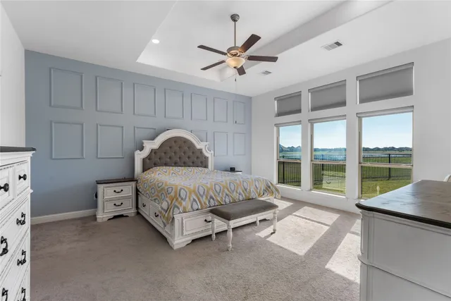 a spacious bedroom with a bed and a large window