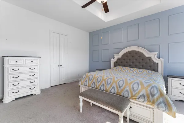 a bedroom with a bed and a dresser