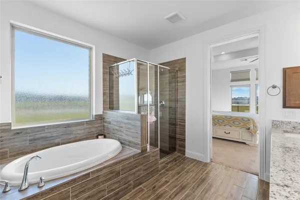 a bathroom with a bathtub and a shower