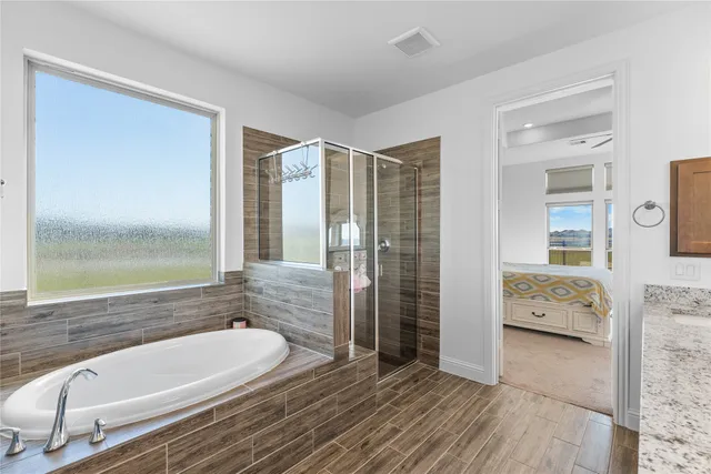 a bathroom with a bathtub and a shower