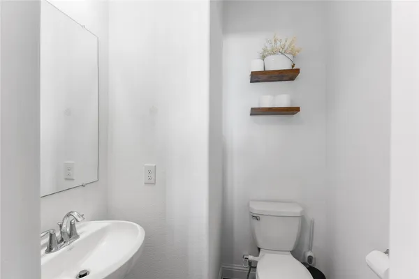 a bathroom with a toilet and a sink