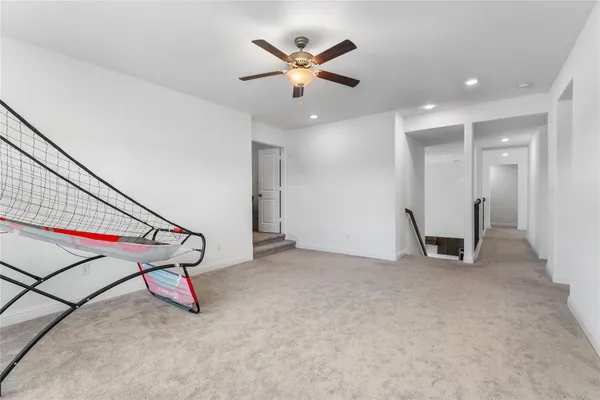 a view of an empty room with ceiling fan