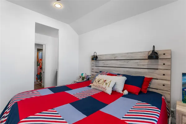 a bedroom with a bed and a lamp