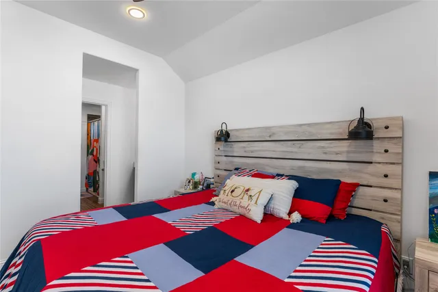 a bedroom with a bed and a lamp