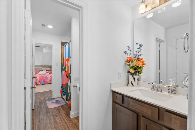 a bathroom with a sink vanity and a mirror