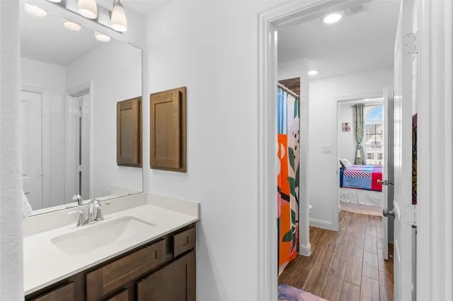 a bathroom with a sink vanity and a mirror