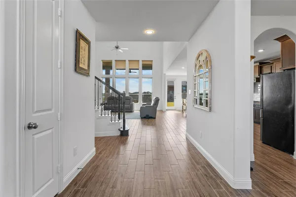 a view of a hallway with wooden floor windows and livingroom