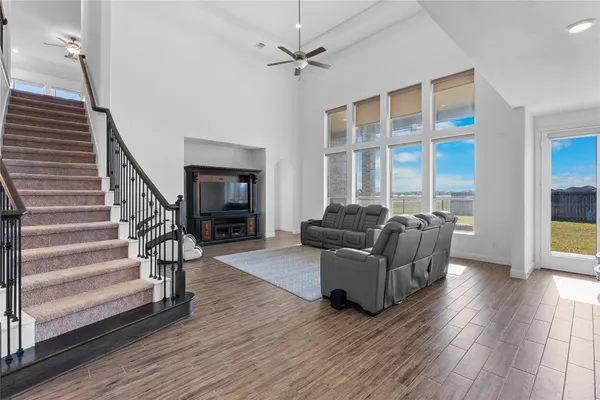 a living room with furniture a fireplace and wooden floor