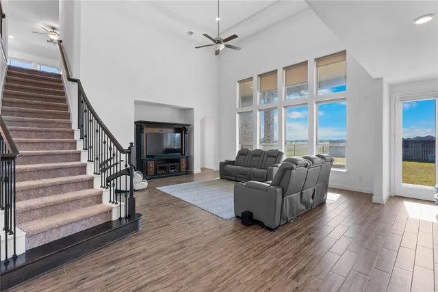 a living room with furniture a fireplace and wooden floor