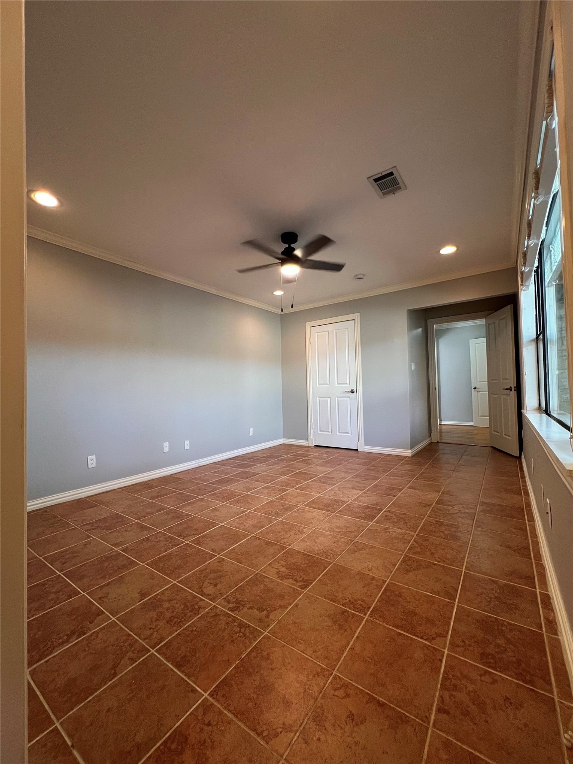4218 Glebe Road Houston, TX 77018 - Photo 15 of 26 a view of an empty room with window and chandelier fan