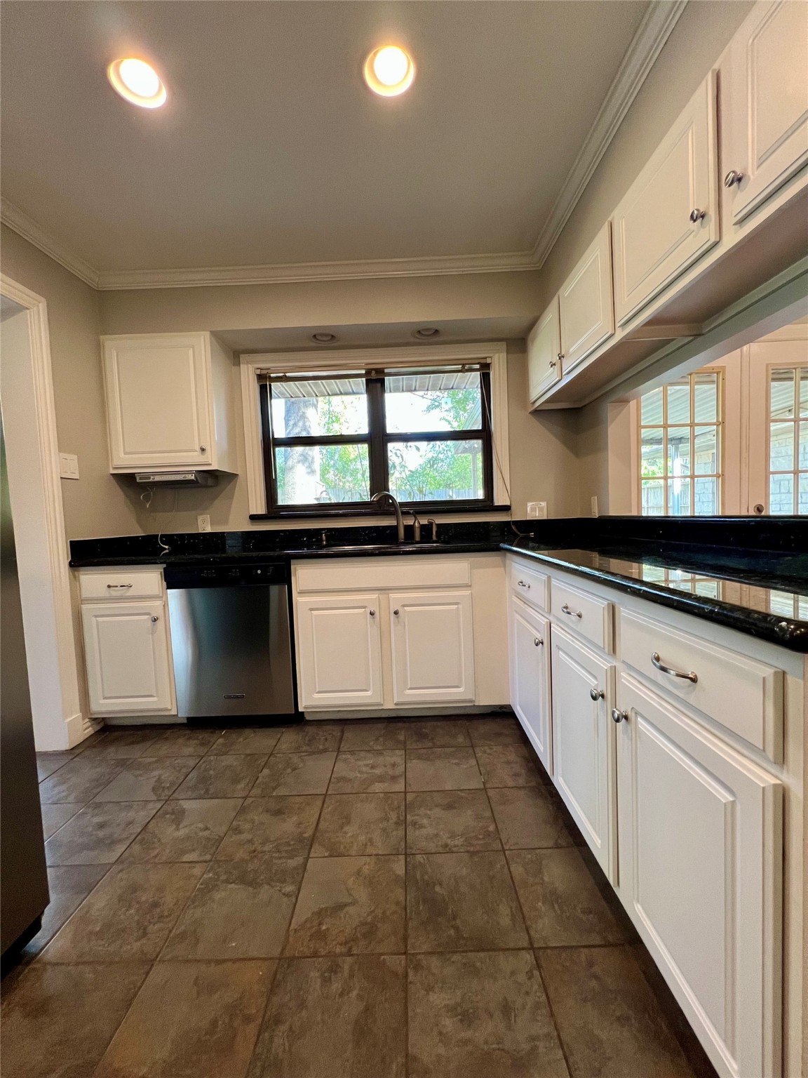 4218 Glebe Road Houston, TX 77018 - Photo 19 of 26 a kitchen with granite countertop a sink window and cabinets