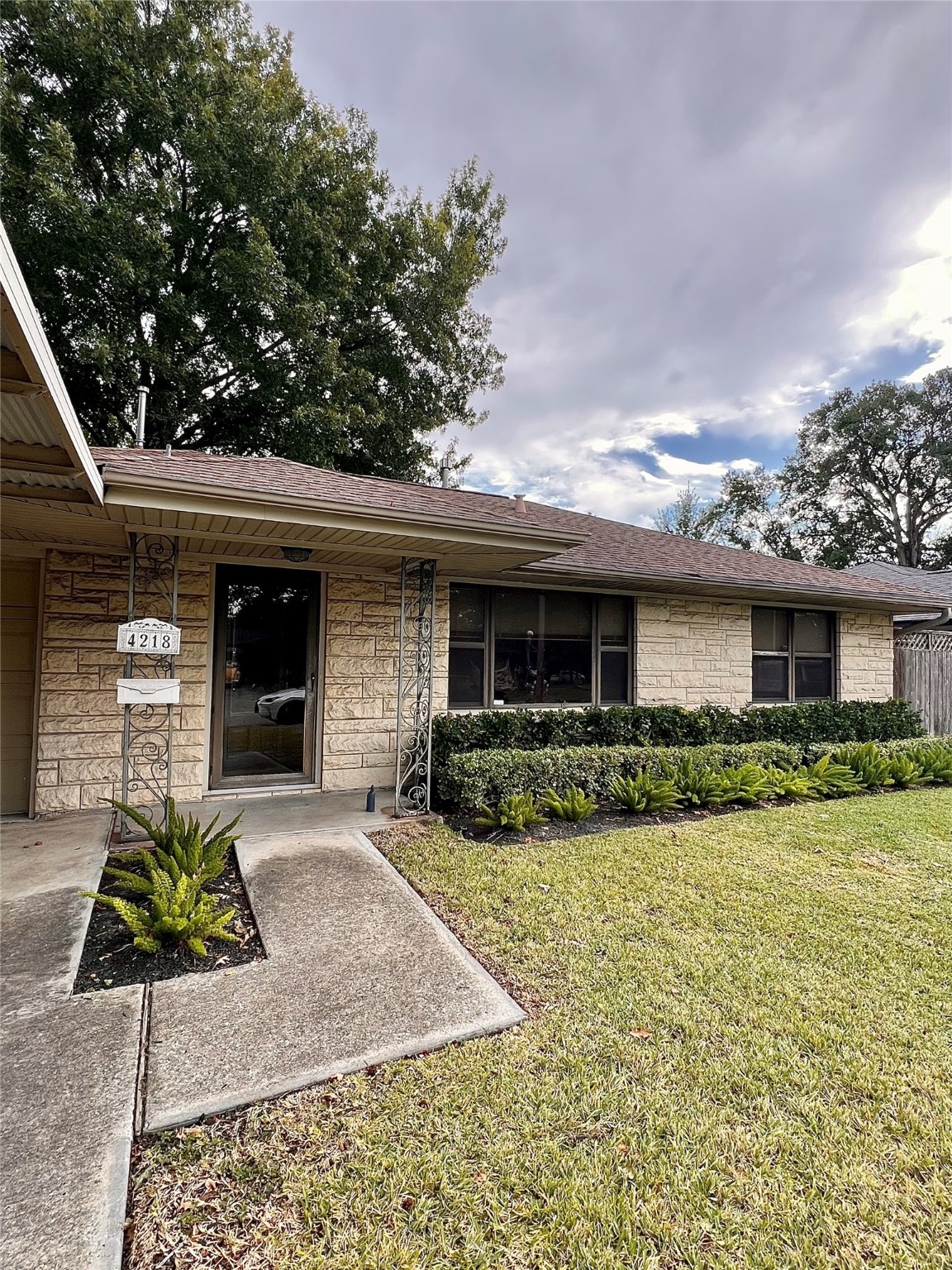 4218 Glebe Road Houston, TX 77018 - Photo 2 of 26 a front view of a house with a yard and garage