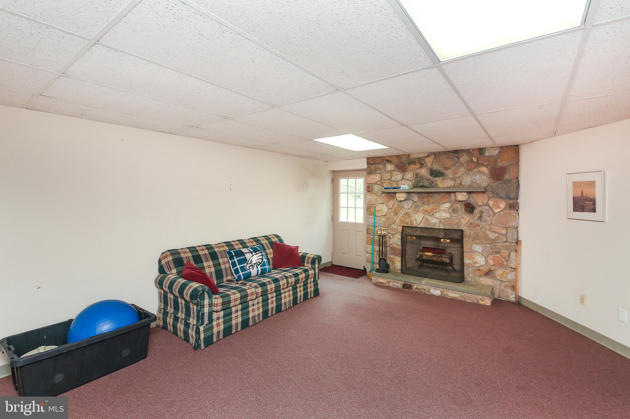 220 Woodhill Road Newtown, PA 18940 - Photo 26 of 28 Basement living area with fireplace