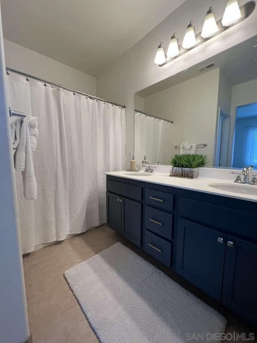 362 Borden Road San Marcos, CA 92069 - Photo 15 of 23 a spacious bathroom with a double vanity sink and a mirror