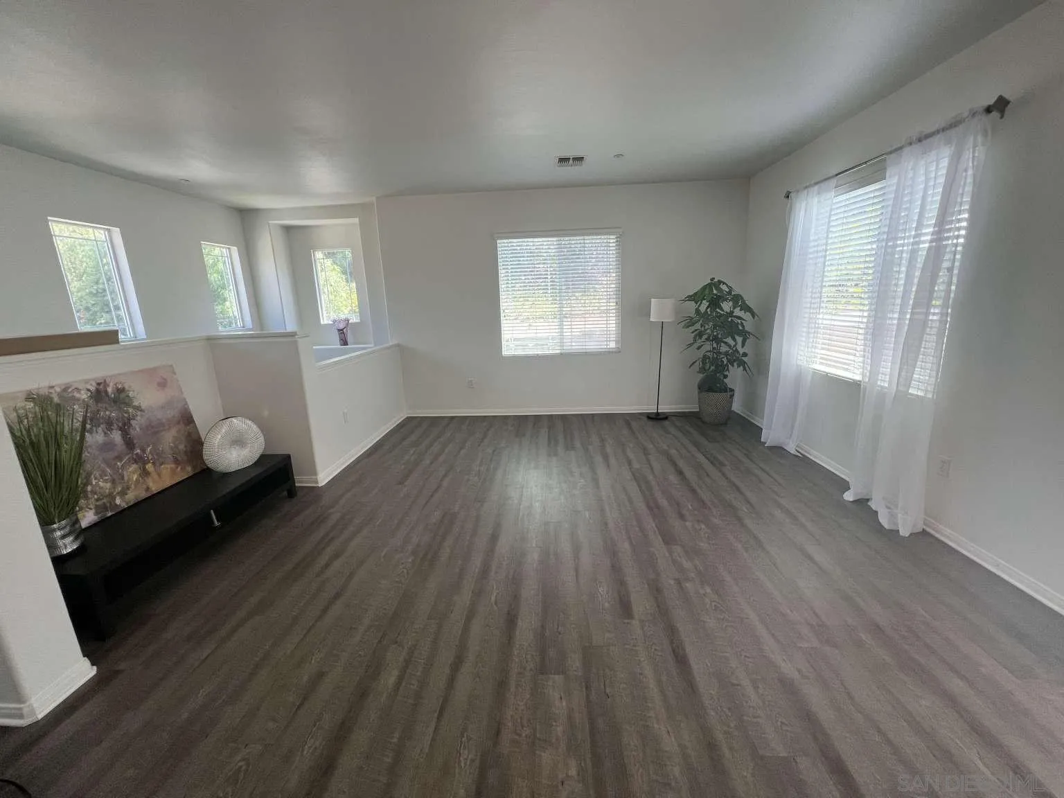 362 Borden Road San Marcos, CA 92069 - Photo 4 of 23 a view of an empty room with wooden floor and a window