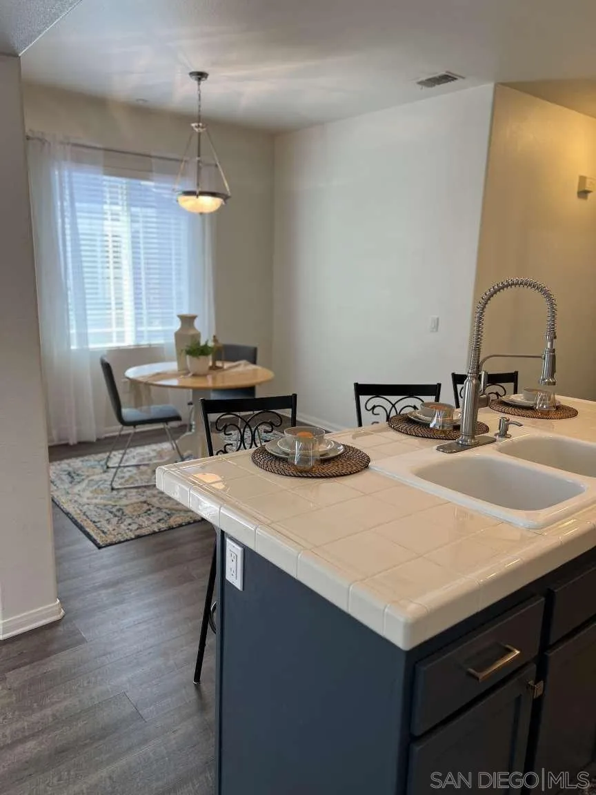 362 Borden Road San Marcos, CA 92069 - Photo 7 of 23 a kitchen with a sink a stove and chairs