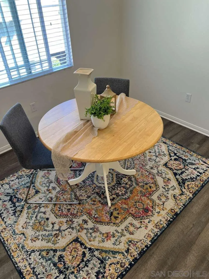 362 Borden Road San Marcos, CA 92069 - Photo 8 of 23 a table with chairs and wooden floor