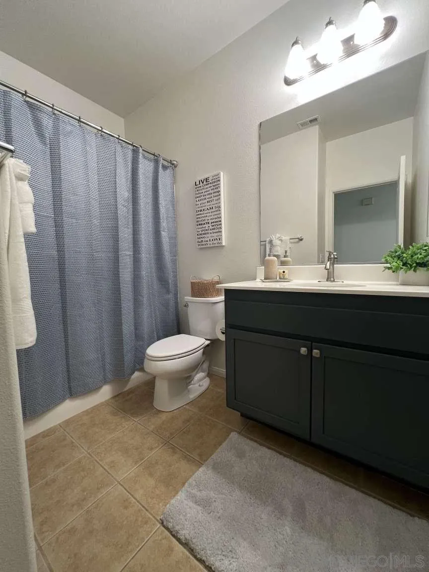 362 Borden Road San Marcos, CA 92069 - Photo 9 of 23 a bathroom with a double vanity sink toilet and a mirror