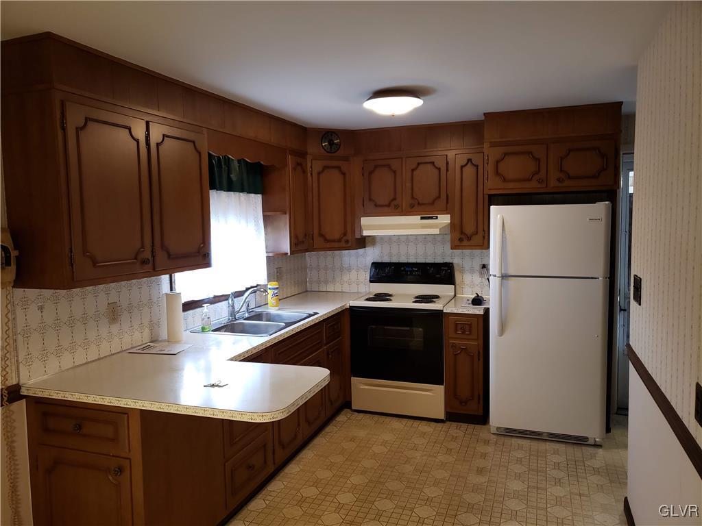 2341 Yost Road Bath, PA 18014 - Photo 12 of 24 a kitchen with granite countertop a refrigerator stove and sink