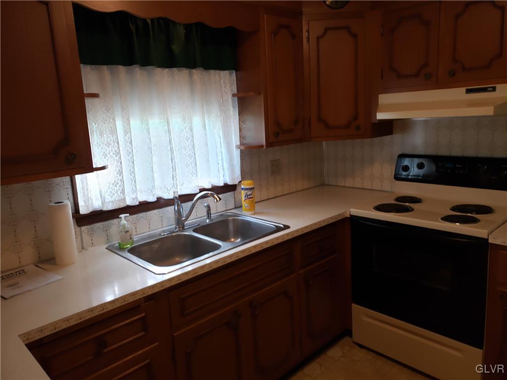 2341 Yost Road Bath, PA 18014 - Photo 13 of 24 a kitchen with a sink dishwasher stove and cabinets
