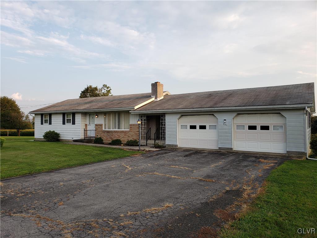 2341 Yost Road Bath, PA 18014 - Photo 3 of 24 a front view of a house with a yard and garage