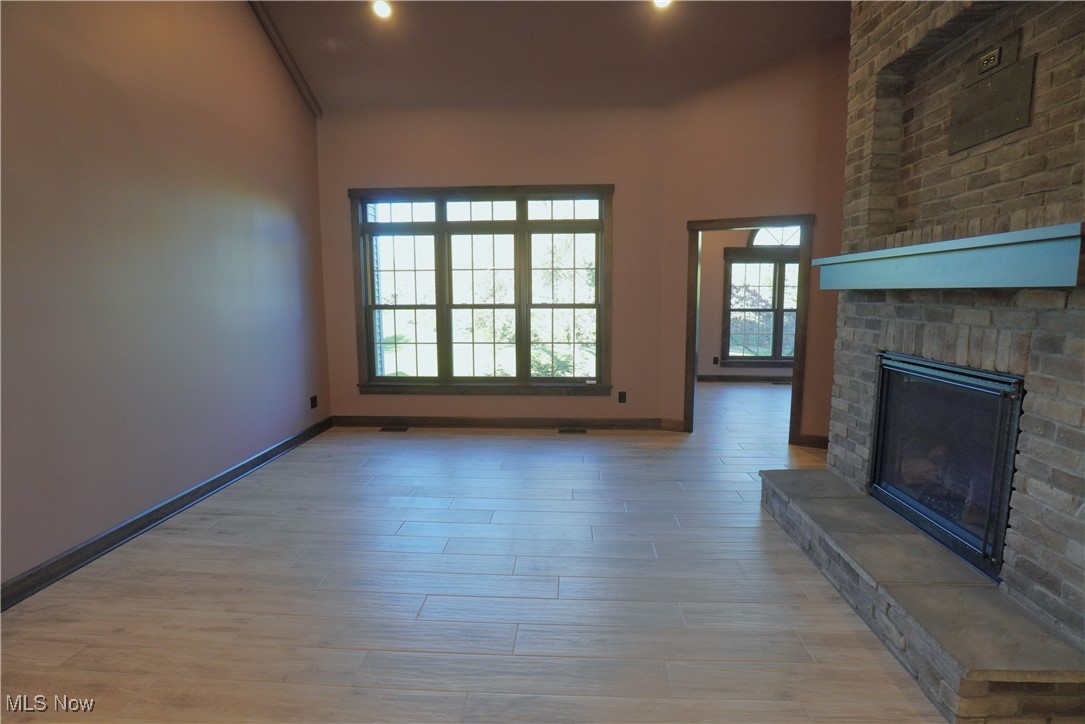 2502 Charing Cross Road Northwest Canton, OH 44708 - Photo 9 of 12 New Ceramic plank flooring gives the condo an amazing flow from every space in the house. The large windows provide loads of natural light and a amazing views of the park like setting with the pond, walking path and trees galore.