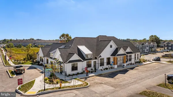 a aerial view of a house with swimming pool and furniture