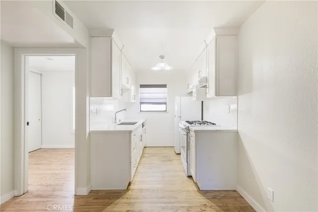 a kitchen with stainless steel appliances a refrigerator and a stove