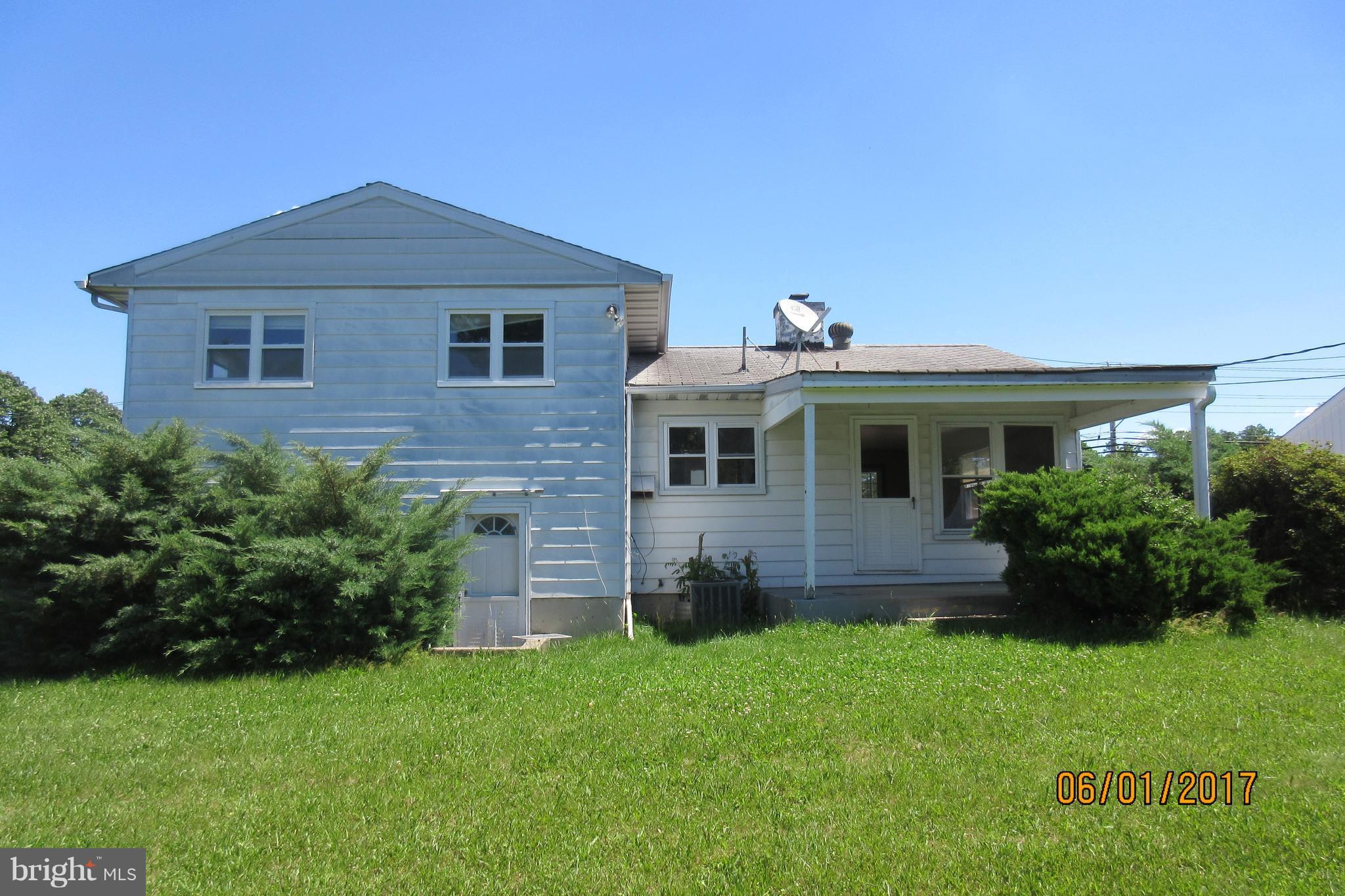 6209 Johnnycake Road Baltimore, MD 21207 - Photo 2 of 15 a front view of a house with a garden