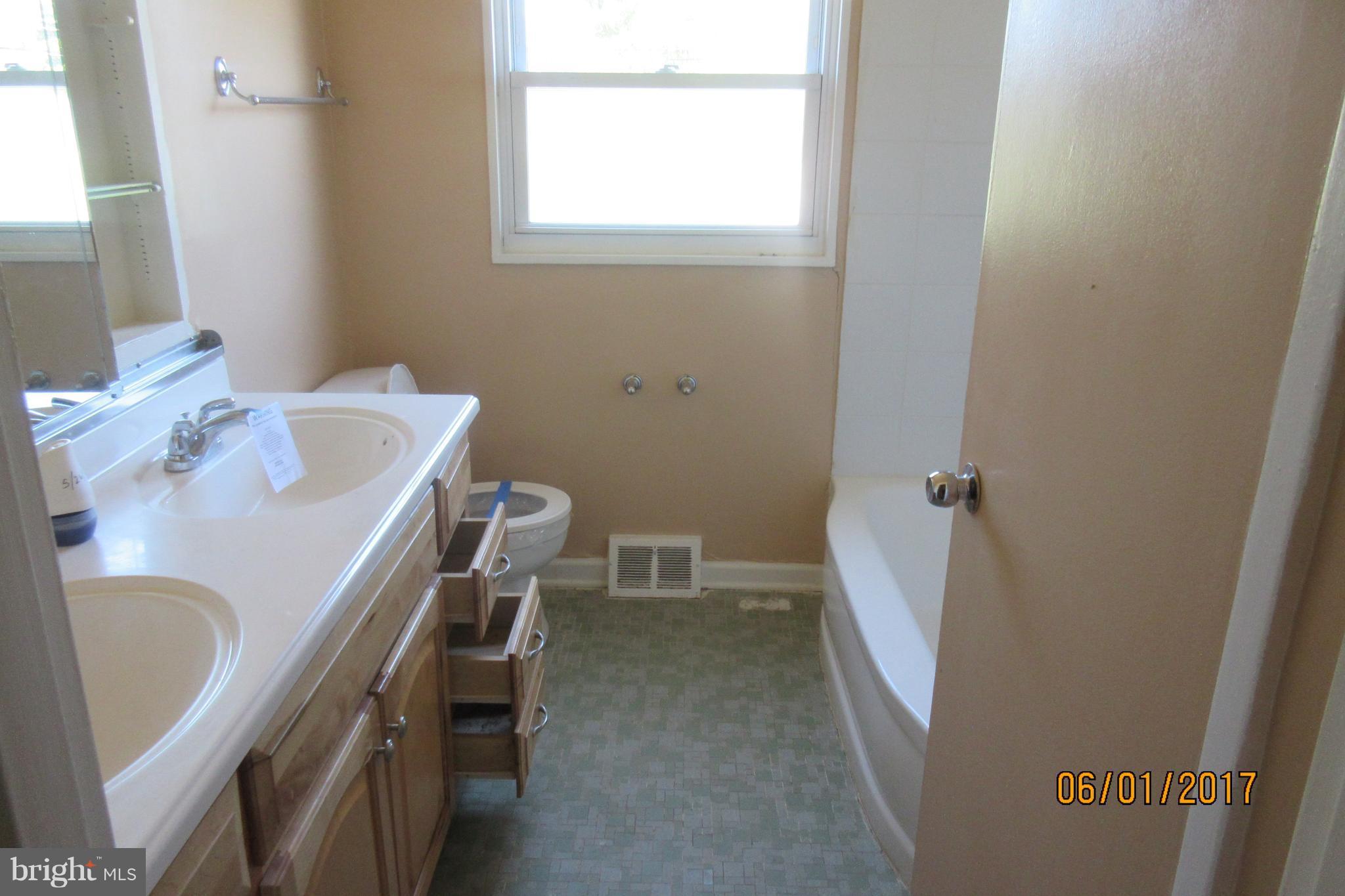 6209 Johnnycake Road Baltimore, MD 21207 - Photo 11 of 15 a room with a table and a chair