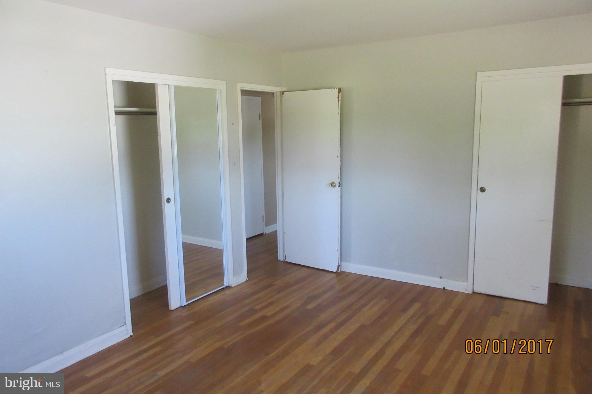 6209 Johnnycake Road Baltimore, MD 21207 - Photo 13 of 15 a view of an empty room with wooden floor and closet