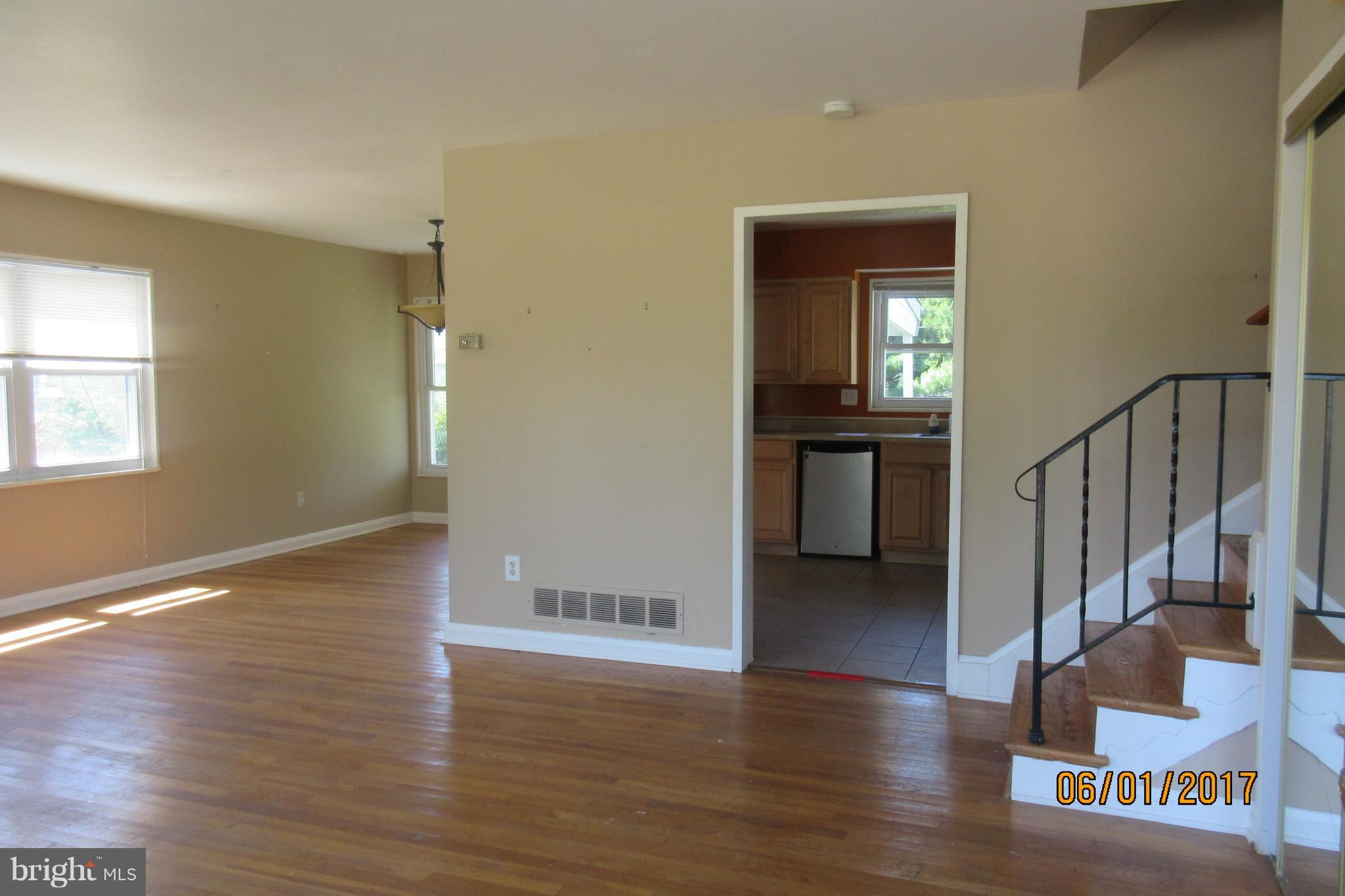 6209 Johnnycake Road Baltimore, MD 21207 - Photo 6 of 15 a view of a hallway with wooden floor and a bathroom