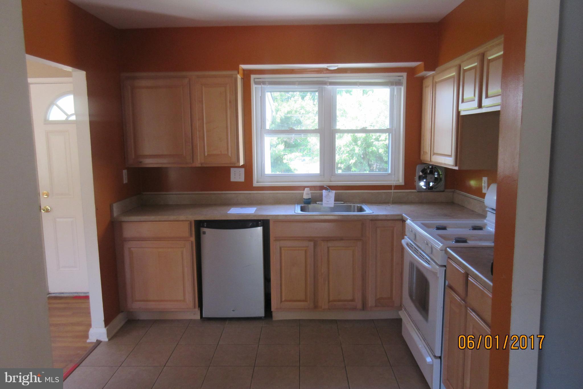 6209 Johnnycake Road Baltimore, MD 21207 - Photo 7 of 15 a kitchen with a sink stove and cabinets