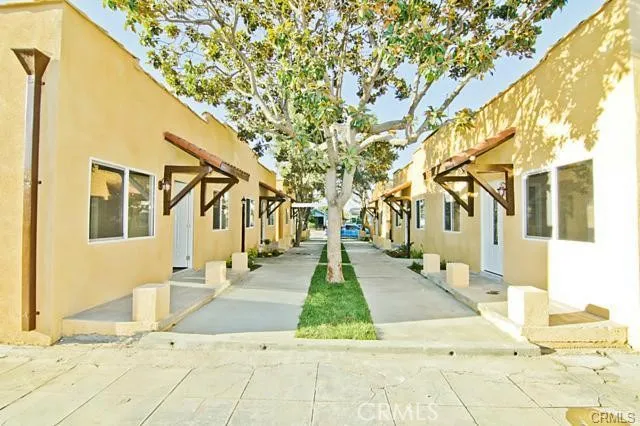 a front view of a house with a yard and trees