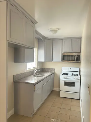 a bathroom with a granite countertop toilet a sink and a mirror